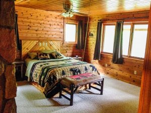 Red Pine Lodge Master Bedroom queen bed, bench and windows